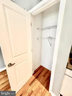 a view of walk in closet with wooden floor