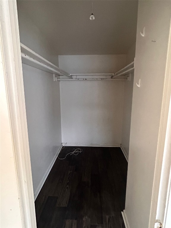 2408 Longview Street, Unit 202 Austin, TX 78705 - Photo 10 of 11 Walk in closet with dark wood finished floors