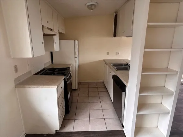 a kitchen with a stove and a refrigerator