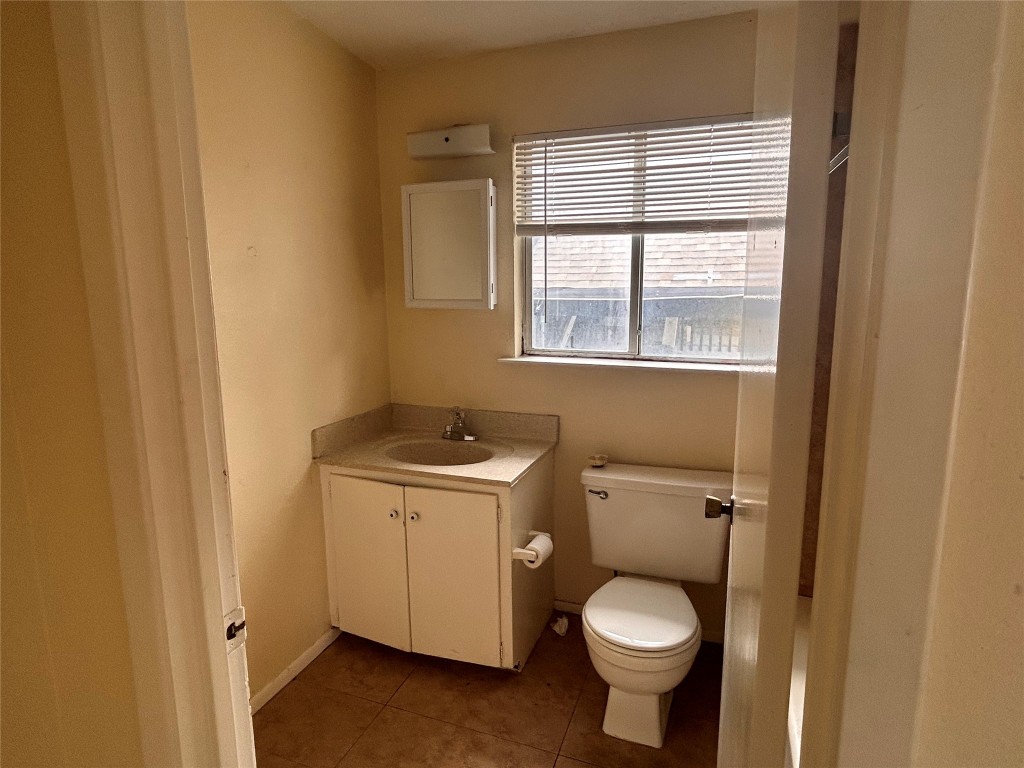 2408 Longview Street, Unit 202 Austin, TX 78705 - Photo 7 of 11 Half bath with vanity and tile patterned floors