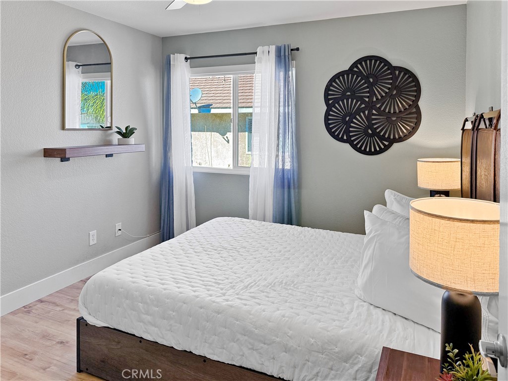 16955 Lake Knoll Parkway Riverside, CA 92503 - Photo 32 of 42 a bedroom with a bed and painting on the wall