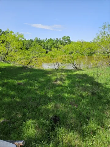 a view of lake with a big yard