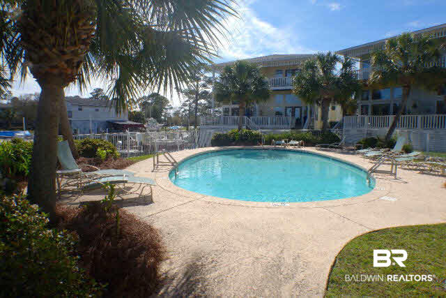 26050 Marina Road, Unit 8 Orange Beach, AL 36561 - Photo 38 of 38 Sparkling clean pool overlooks the marina and is enjoyed from decks of the condo! This is the view looking toward the condo and will give an idea how close proximity it is from the back deck.