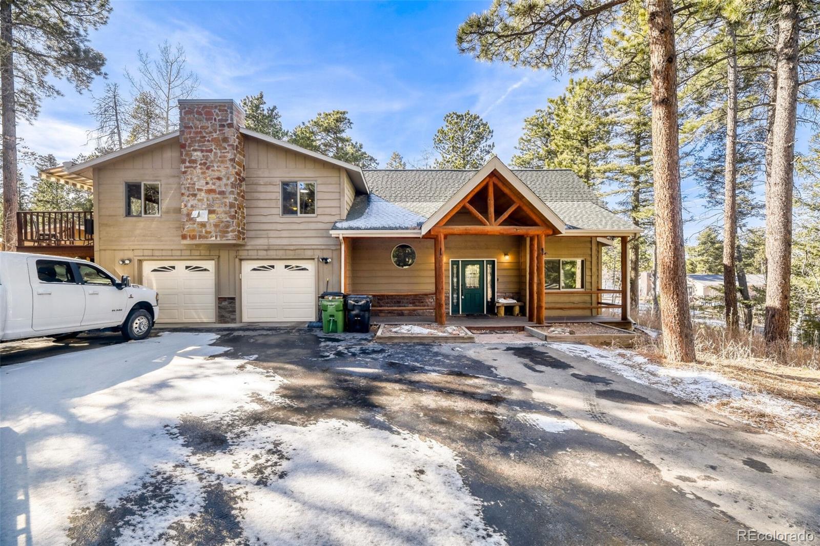 26196 Rea Avenue Conifer, CO 80433 - Photo 1 of 46 a view of a house with a patio