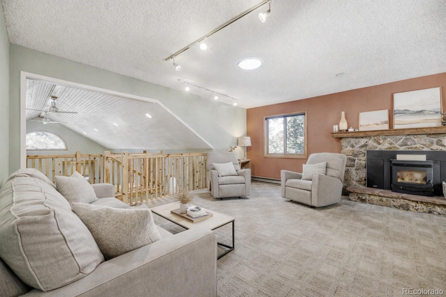 26196 Rea Avenue Conifer, CO 80433 - Photo 12 of 46 a living room with furniture and a fireplace