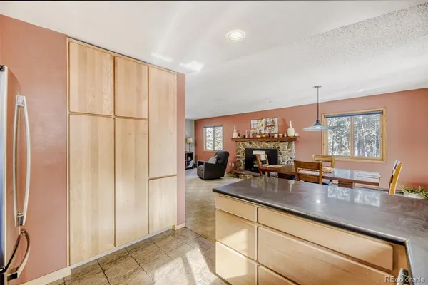 a kitchen with sink refrigerator and window