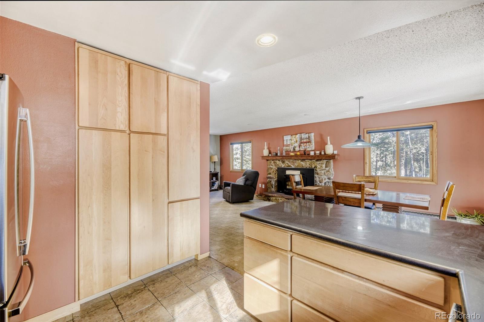 26196 Rea Avenue Conifer, CO 80433 - Photo 15 of 46 a kitchen with sink refrigerator and window