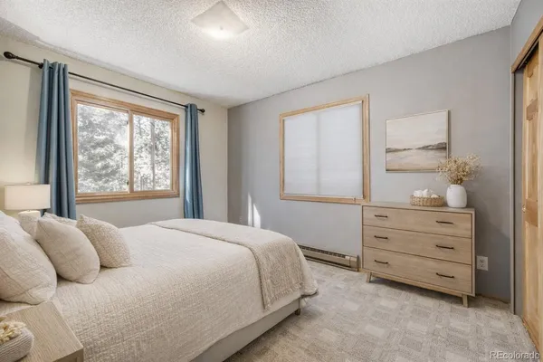 a bedroom with a bed and a dresser