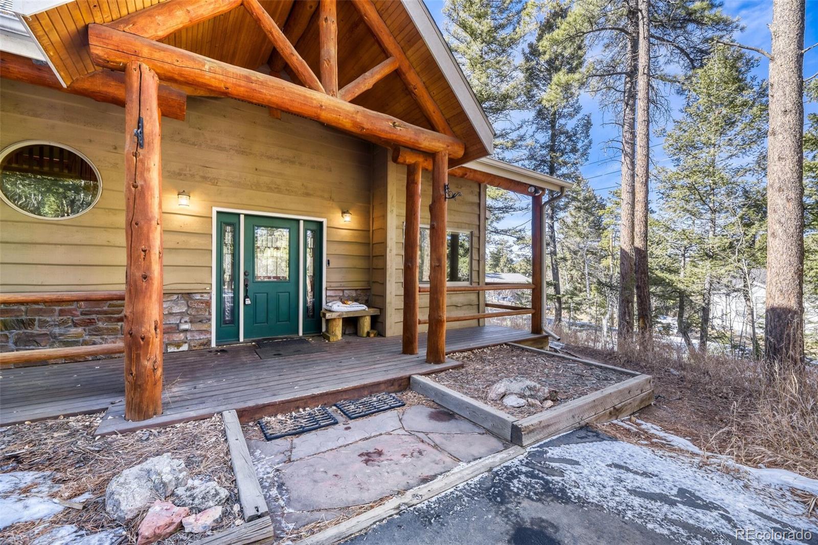 26196 Rea Avenue Conifer, CO 80433 - Photo 2 of 46 a front view of a house with a yard