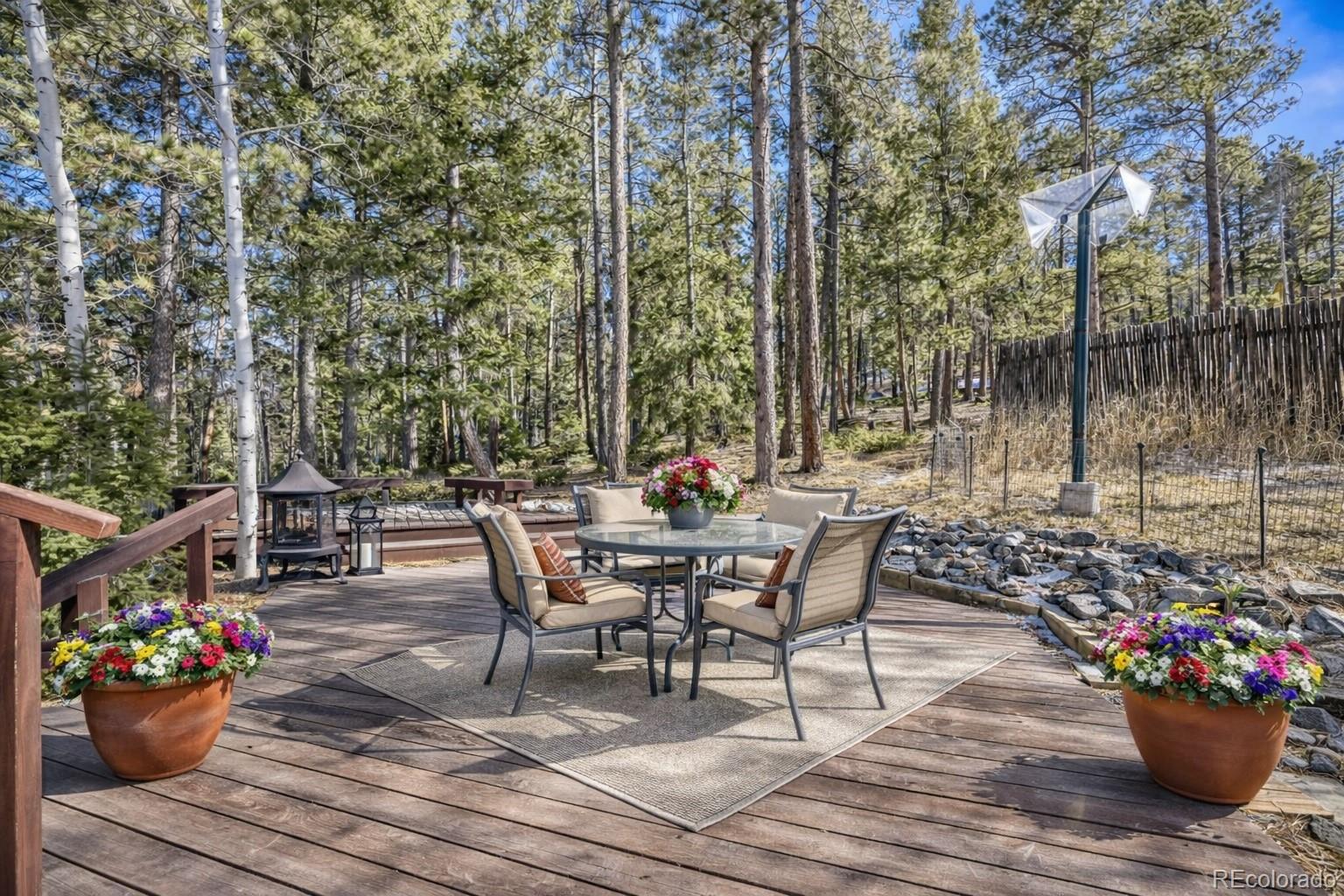 26196 Rea Avenue Conifer, CO 80433 - Photo 22 of 46 a view of a dining table and chairs in the patio