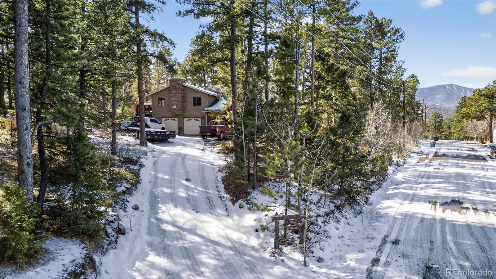 26196 Rea Avenue Conifer, CO 80433 - Photo 27 of 46 a view of house with outdoor space and trees