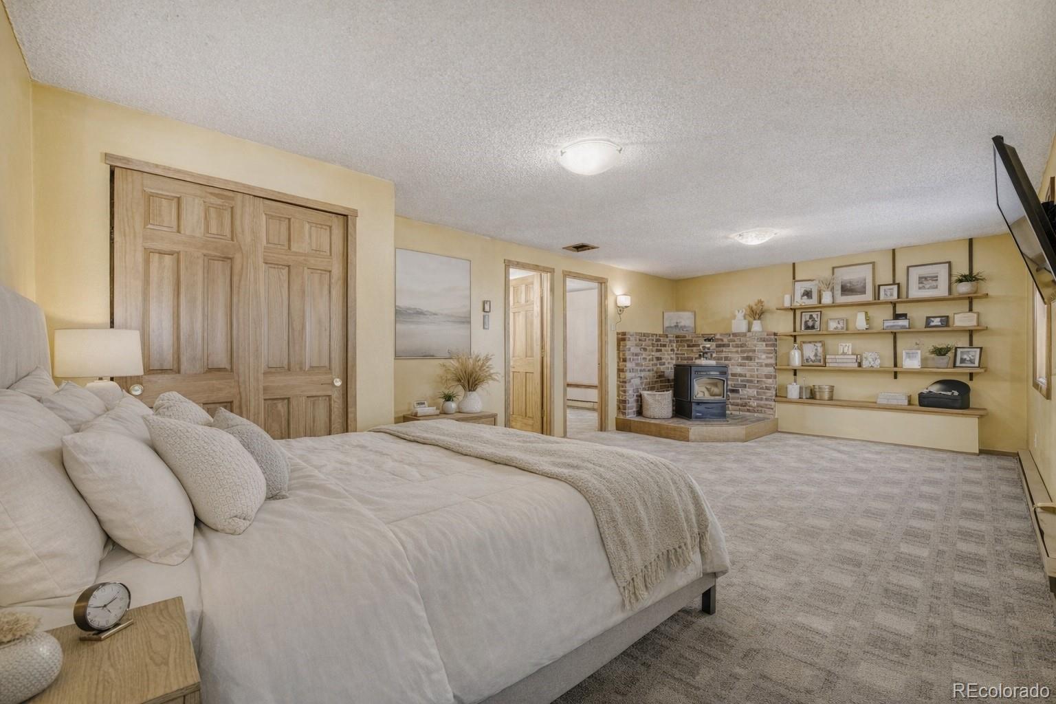 26196 Rea Avenue Conifer, CO 80433 - Photo 6 of 46 a bed room with a bed and a large closet
