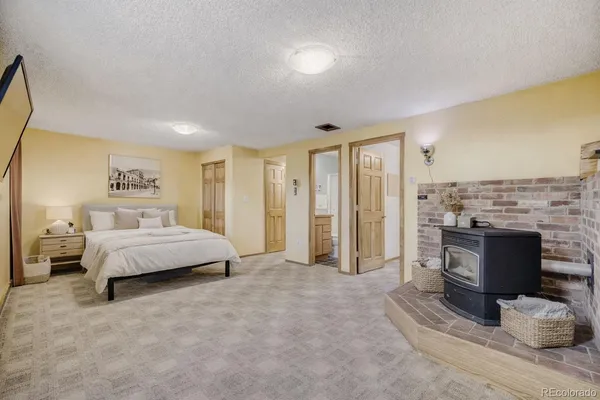 a spacious bedroom with a bed and a couch