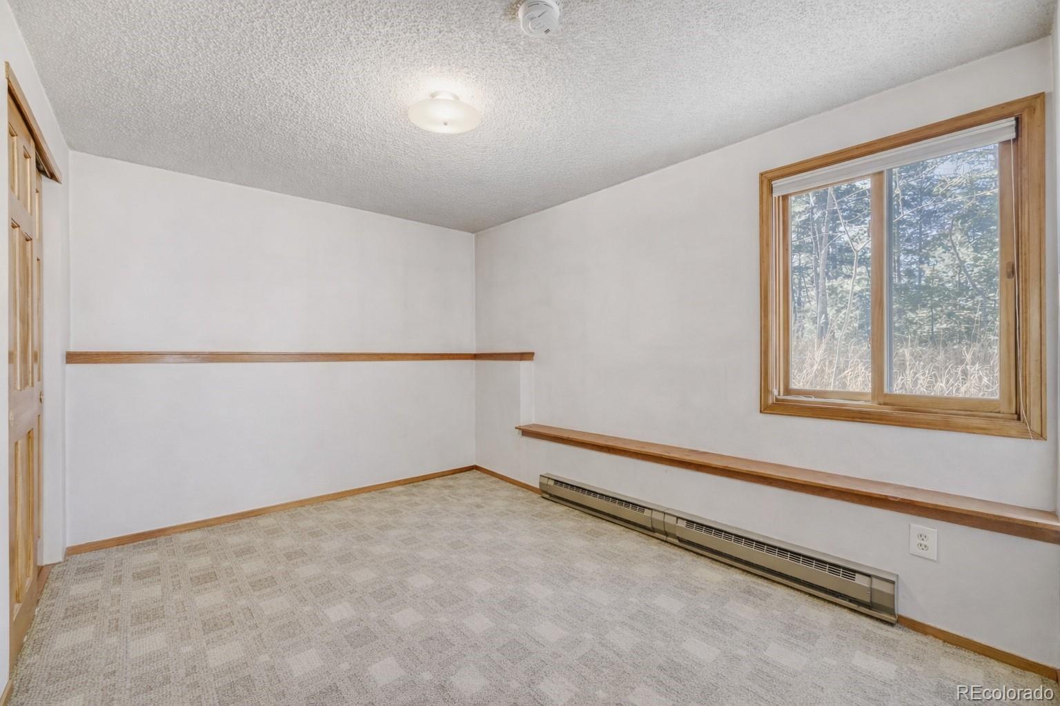 26196 Rea Avenue Conifer, CO 80433 - Photo 8 of 46 an empty room with a window