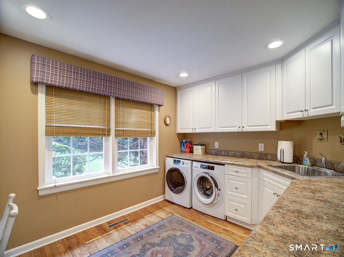 19 East Ridge Court Cheshire, CT 06410 - Photo 21 of 39 Large laundry room has built in hamper and ironing board. Abundace of storage and counter space.