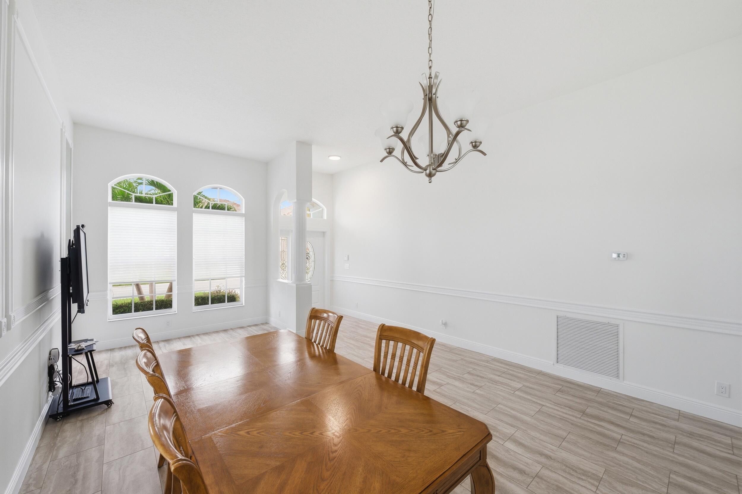 8534 Vía D Oro Boca Raton, FL 33433 - Photo 7 of 34 a view of a dining room with furniture window and wooden floor