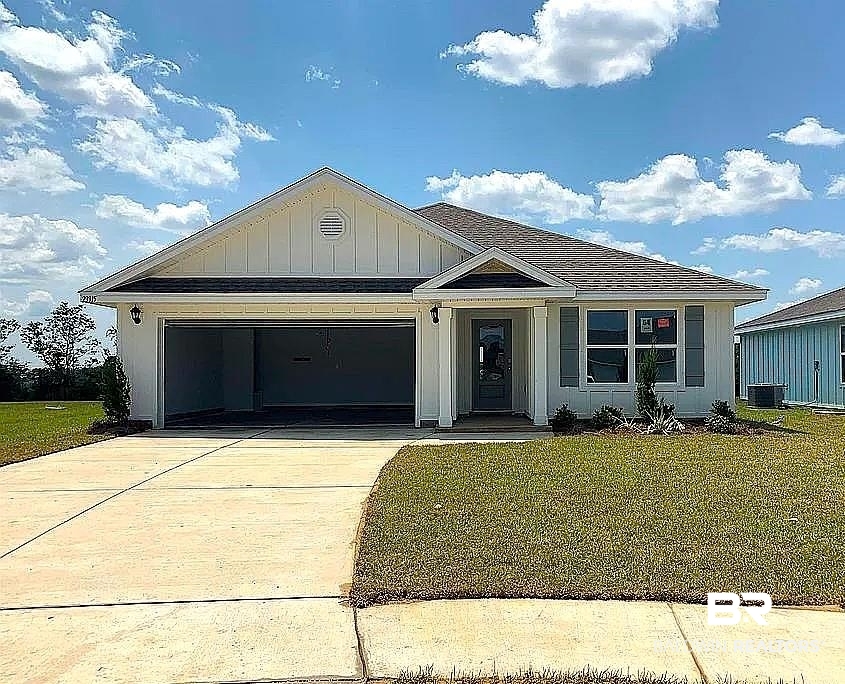 23915 Veranda Circle Elberta, AL 36530 - Photo 1 of 16 View of front of house with concrete driveway, a front yard, an attached garage, and board and batten siding