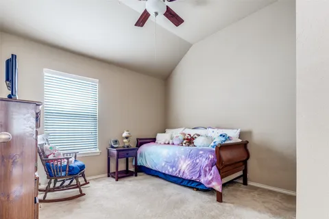 a bedroom with a bed and a chair