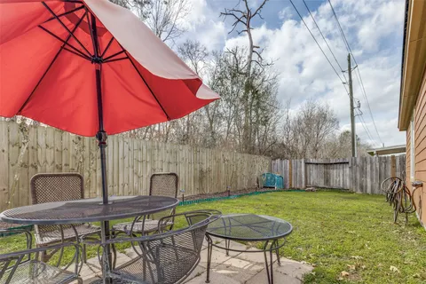 a backyard of a house with table and chairs