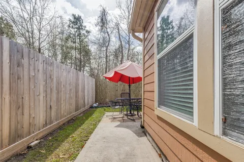 a view of a patio with a table and chairs and couches