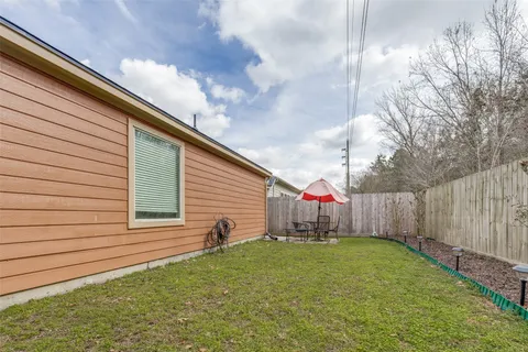 a backyard of a house with table and chairs