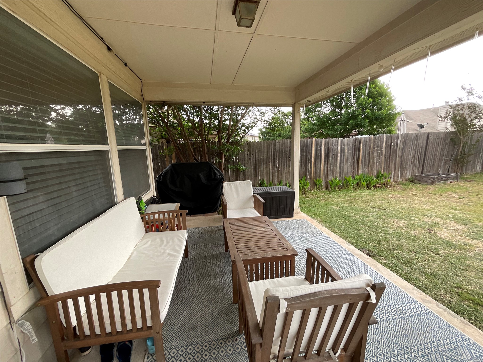 14013 Rountree Ranch Lane Austin, TX 78717 - Photo 18 of 19 Fenced backyard featuring a patio area, outdoor lounge area, and grilling area