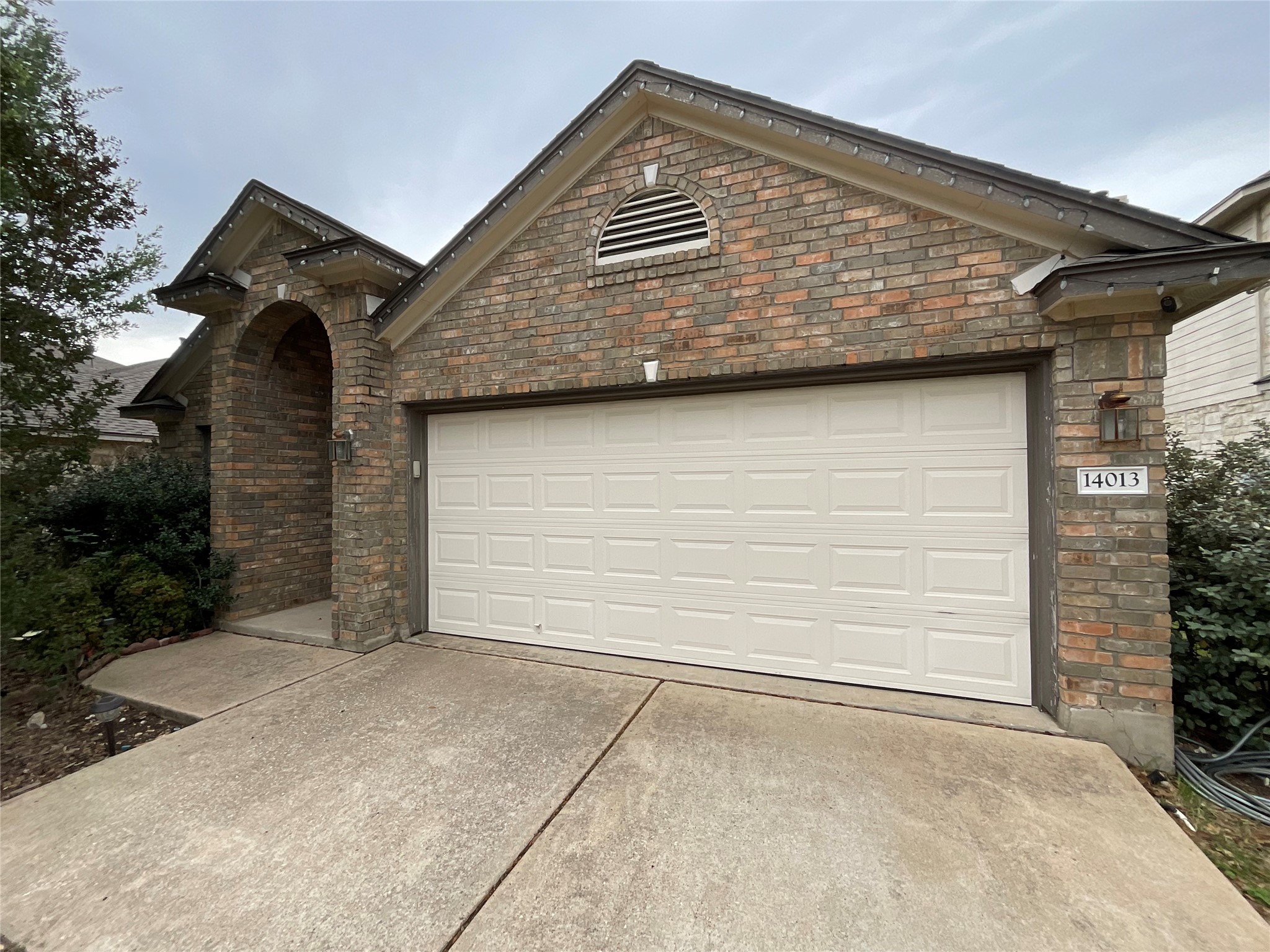 14013 Rountree Ranch Lane Austin, TX 78717 - Photo 2 of 19 View of front of house with concrete driveway, an attached garage, and stone siding