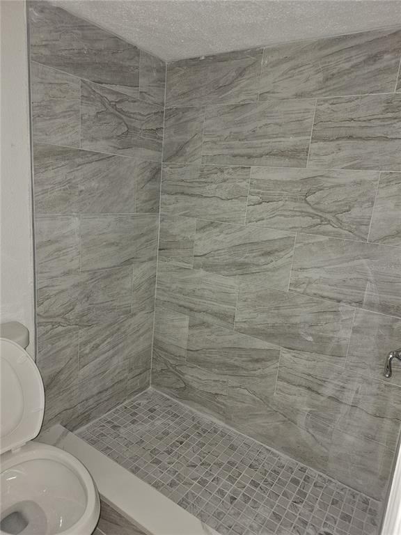 5132 Conroy Road, Unit 937 Orlando, FL 32811 - Photo 5 of 6 a bathroom with a toilet and a shower