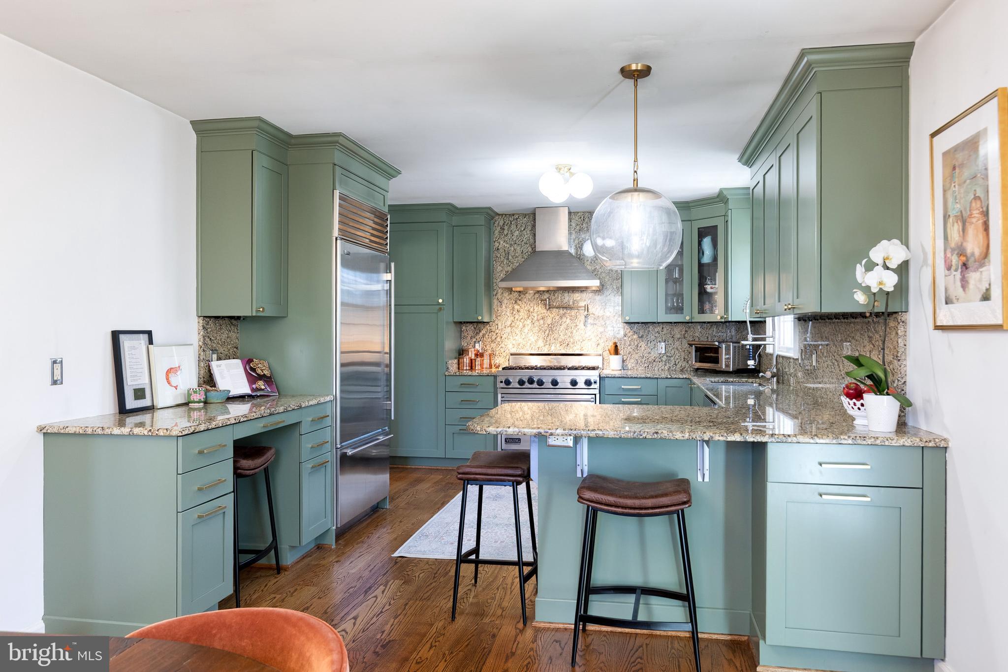 232 Cardamon Drive Edgewater, MD 21037 - Photo 12 of 44 a kitchen with kitchen island granite countertop wooden cabinets and a chandelier