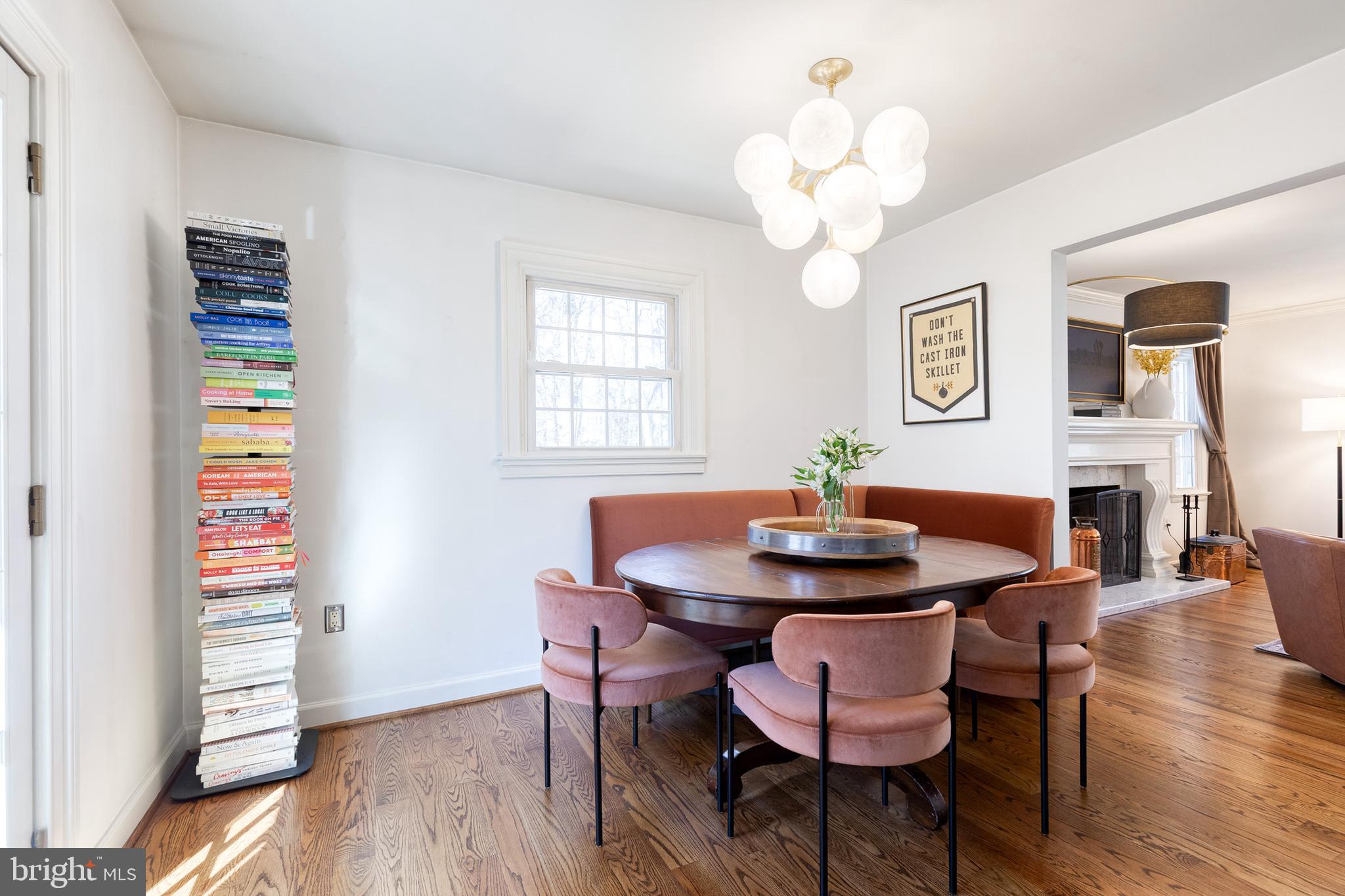 232 Cardamon Drive Edgewater, MD 21037 - Photo 15 of 44 a dining room with wooden floor a chandelier a wooden table and chairs