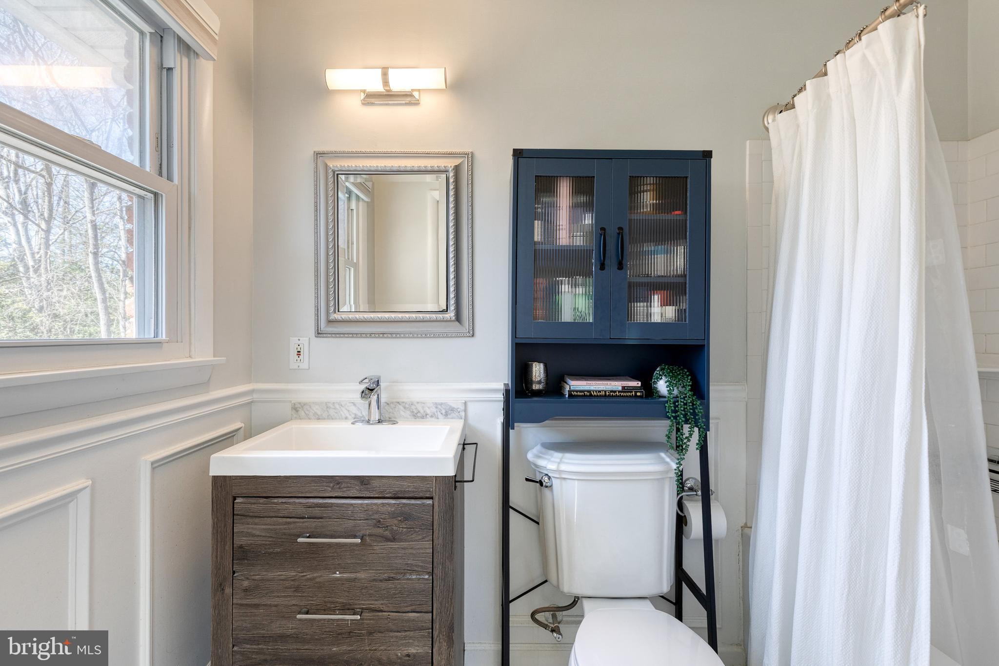 232 Cardamon Drive Edgewater, MD 21037 - Photo 18 of 44 a bathroom with a sink toilet and window