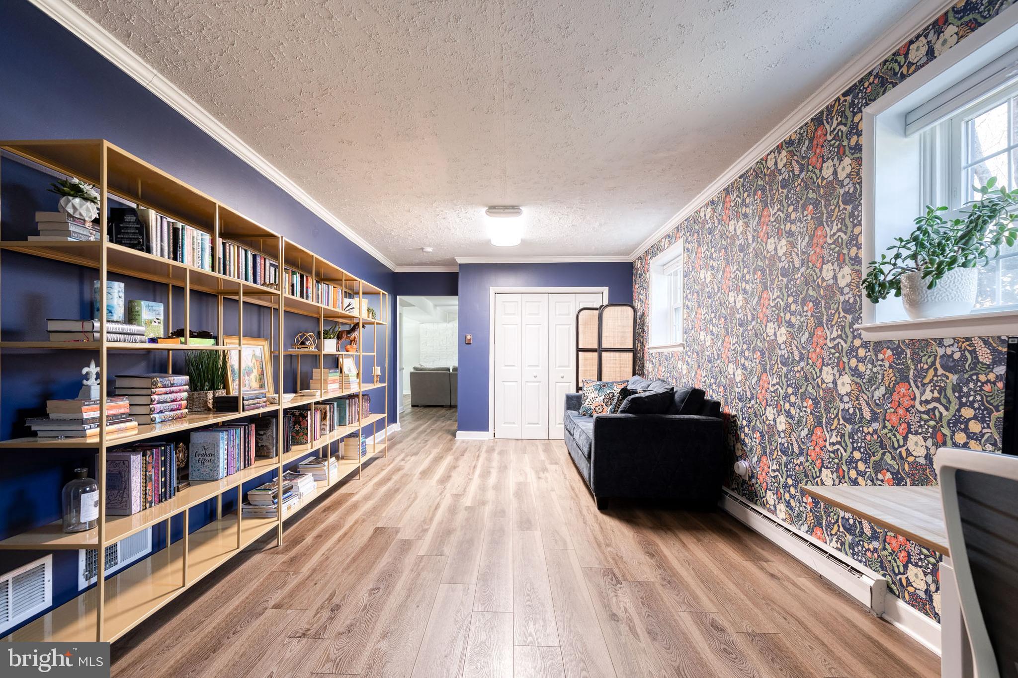 232 Cardamon Drive Edgewater, MD 21037 - Photo 28 of 44 a living room with furniture and a book shelf