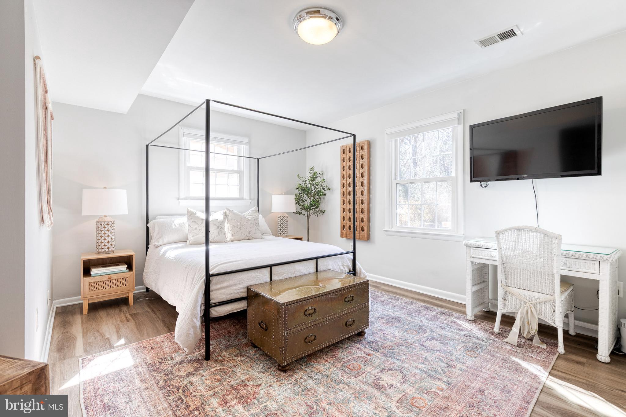 232 Cardamon Drive Edgewater, MD 21037 - Photo 30 of 44 a spacious bedroom with a bed and a flat screen tv