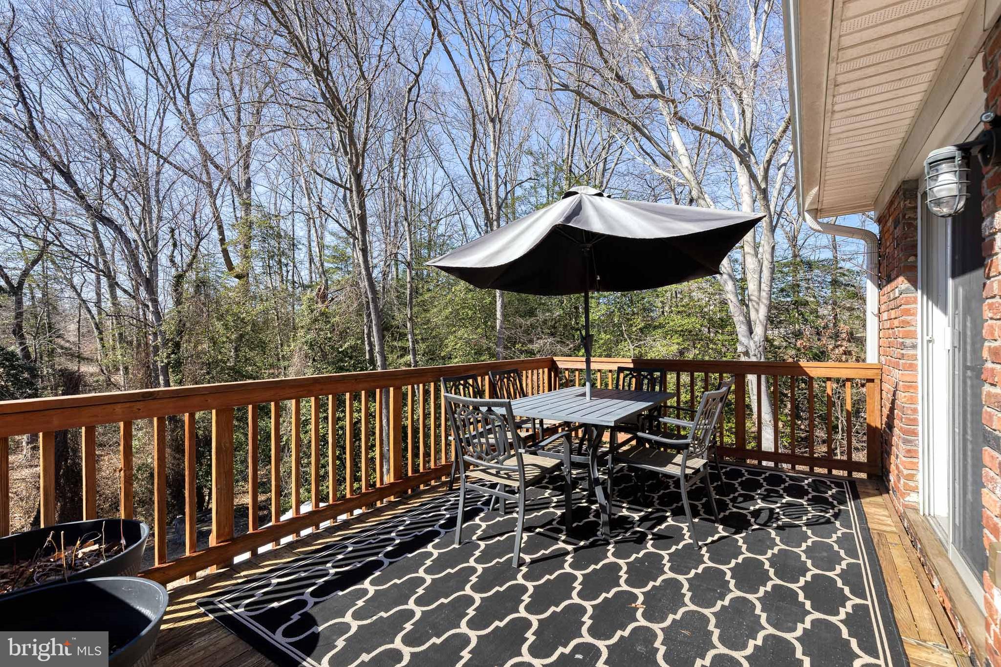 232 Cardamon Drive Edgewater, MD 21037 - Photo 35 of 44 a view of a balcony with chairs and wooden fence