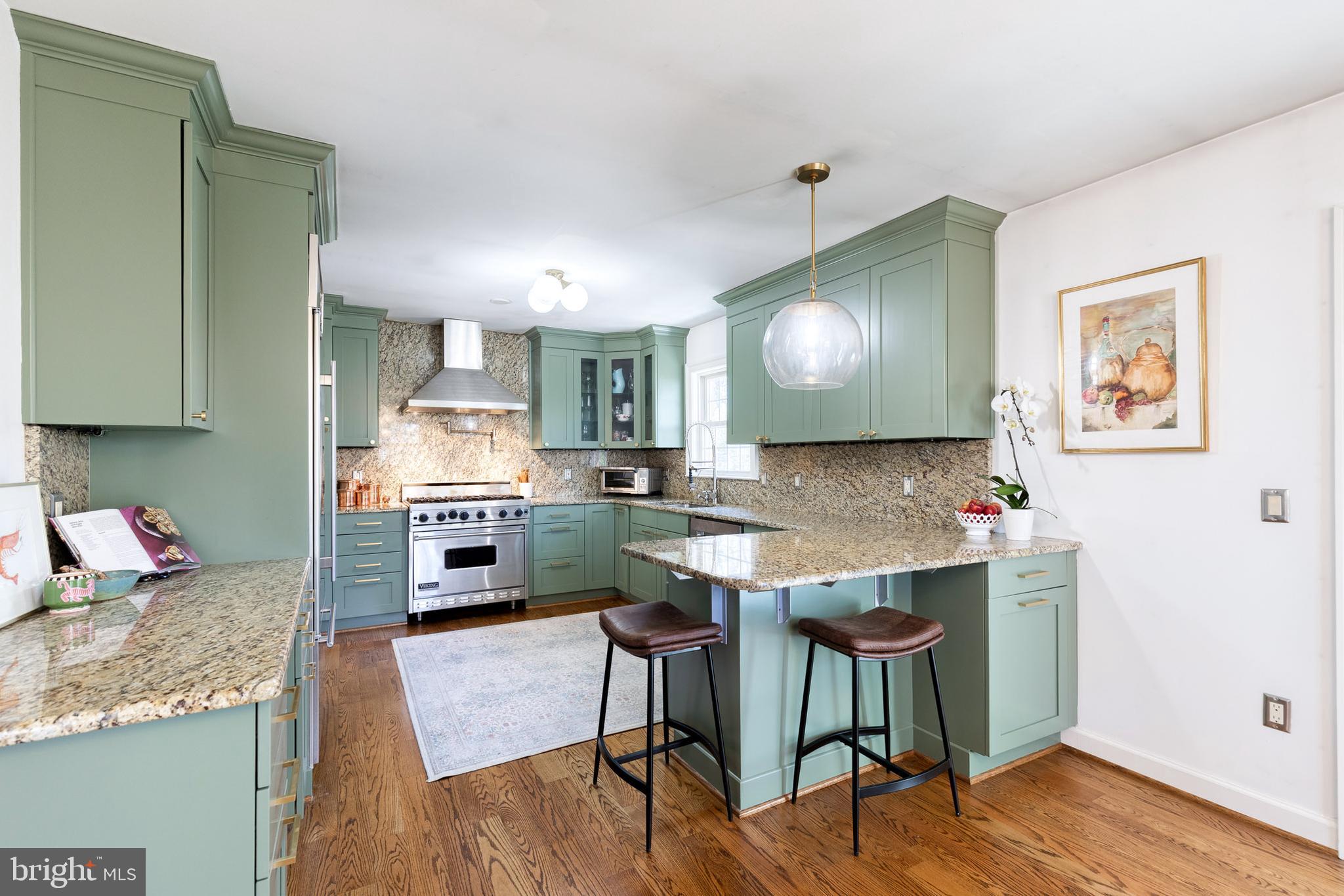 232 Cardamon Drive Edgewater, MD 21037 - Photo 4 of 44 a kitchen with stainless steel appliances granite countertop a stove top oven a sink dishwasher and cabinets with wooden floor