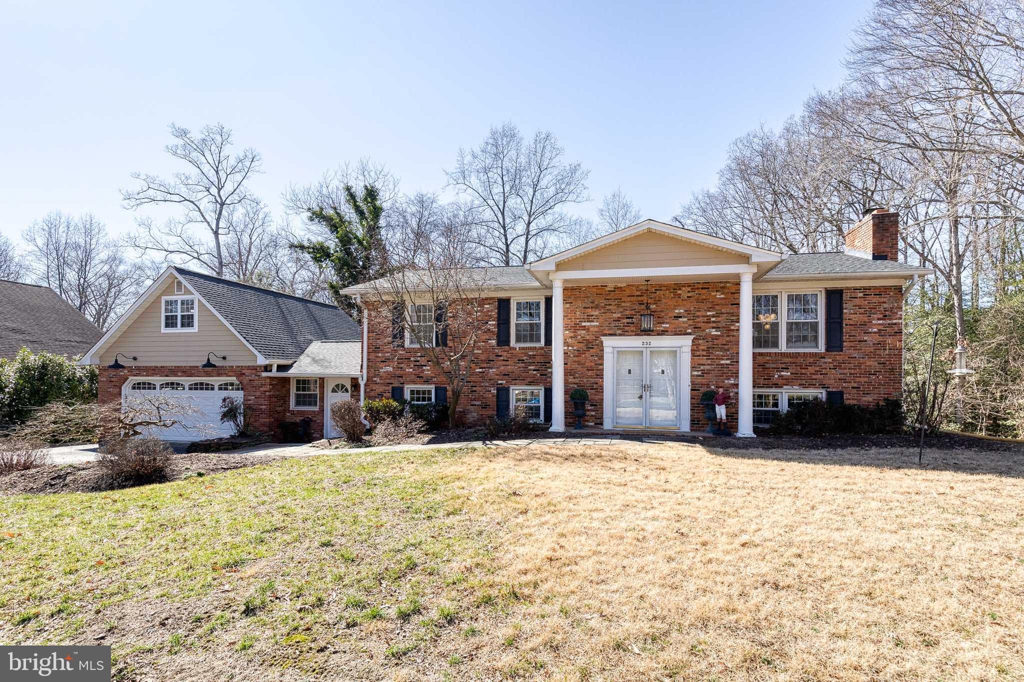 232 Cardamon Drive Edgewater, MD 21037 - Photo 5 of 44 a front view of a house with a yard covered in snow