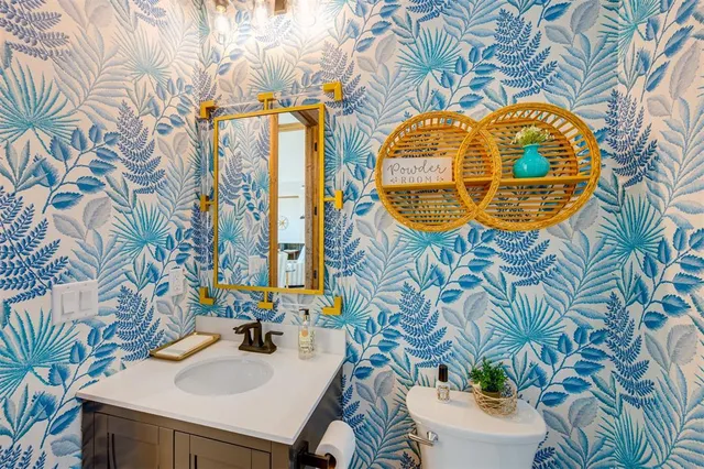 a bathroom with a sink mirror and vanity