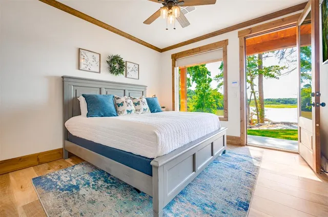 a bed sitting in a bedroom next to a window