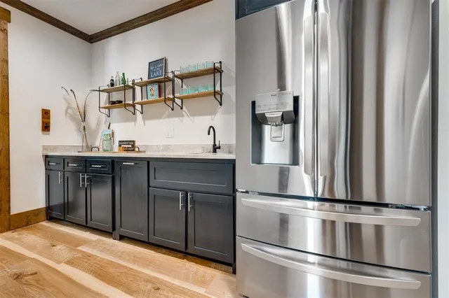 a kitchen with kitchen island a counter top space cabinets and stainless steel appliances