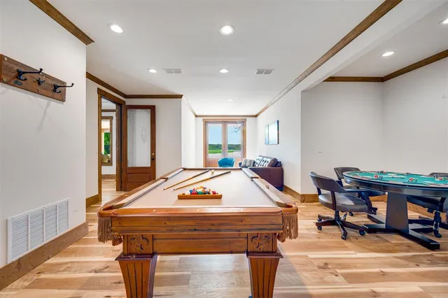 a room with furniture pool table and windows