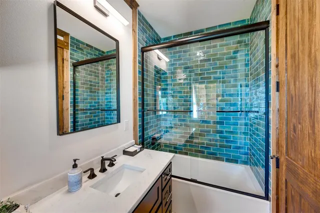a bathroom with a shower and a sink
