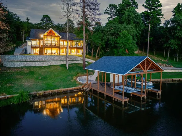 a view of a house with pool and chairs