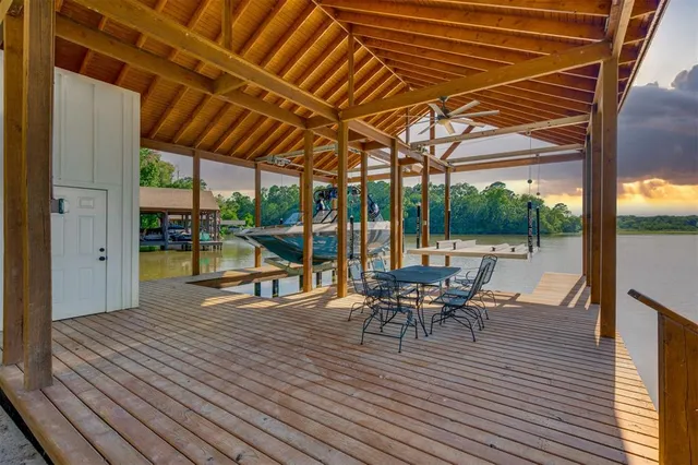a view of a patio with table and chairs and wooden floor