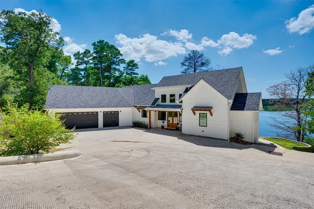 a view of a house with a yard and potted plants
