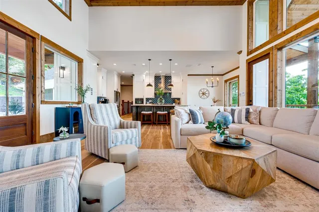 a living room with fireplace furniture and a large window
