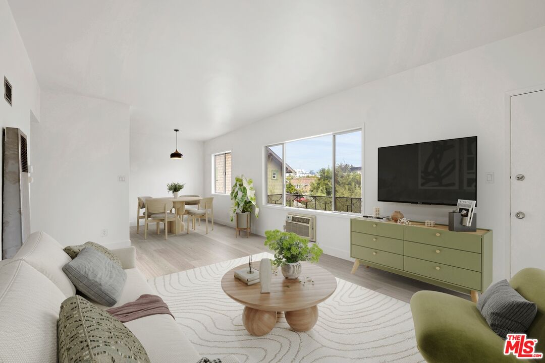 200 North Rampart Boulevard Los Angeles, CA 90026 - Photo 2 of 16 a living room with furniture and a flat screen tv