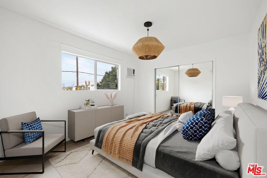 200 North Rampart Boulevard Los Angeles, CA 90026 - Photo 10 of 16 a bedroom with a bed and window