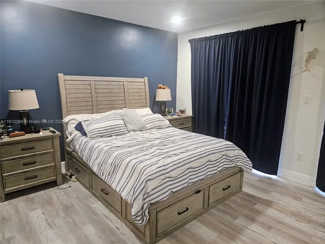 a bedroom with a bed and a mirror