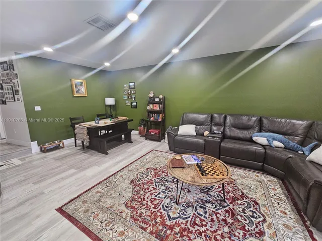 a living room with furniture and a rug