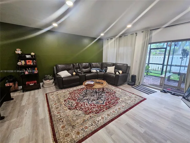 a living room with furniture and a rug